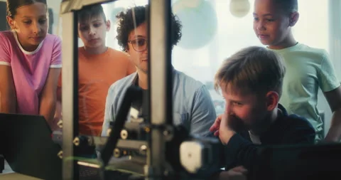 Team of Talented Kids Studying Advanced Automated 3D Printer with Teacher Stock Footage 311675336