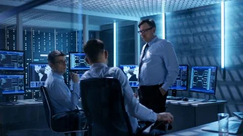 Team of Technical Moderators Have Discussion in Monitoring Room. System Contr 스톡 사진