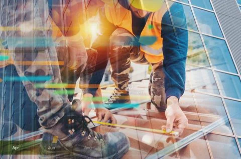 Team of technical workers work on the roof of a house Stock Photos