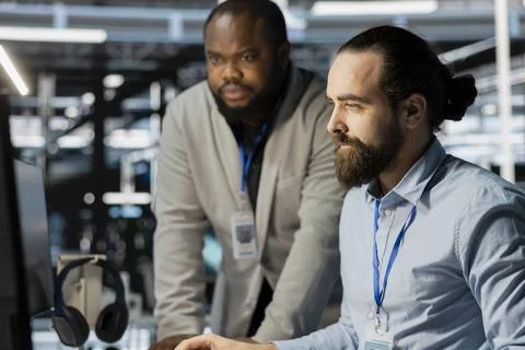 Team of technicians in data center using PC to update storage arrays software Stock Photos