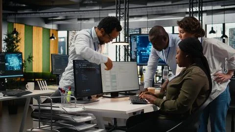 Team of technicians in office working together, automating workflows using AI Stock Photos