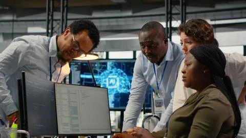 Team of technicians in office working together, automating workflows using AI Stock Photos
