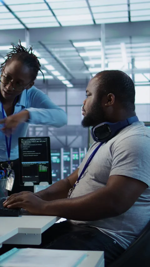 Team of technicians using PC to check for system failures in data center Stock Footage 319569221