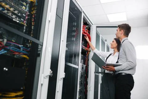  Team of technicians working on servers in large data center Team of techn... Stock Photos