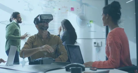 Team testing virtual reality tech in office, displaying floating code overlays Stock Footage 307434844