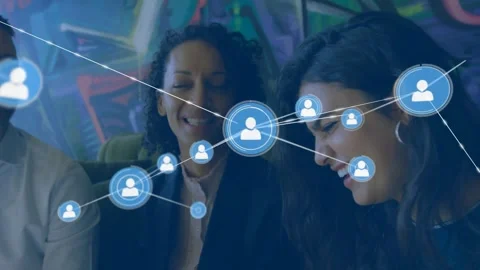 Team of three chatting on sofa, node emerging over group, blue nodes linking Stock Footage 332285844
