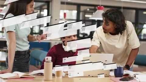 Team of three reviewing code on laptop in tech hub, left member initiating Stock Footage 333463397