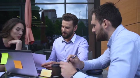 Team of three workers looking at laptop screen Stock Footage 64284783