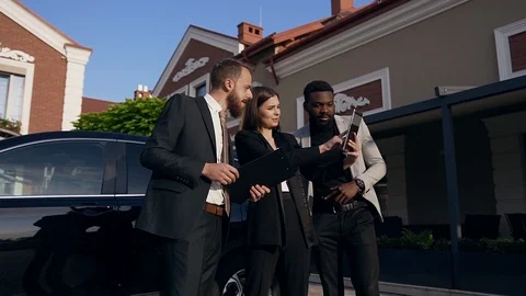 Team of three young mixed-race office workers using tablet computer and worker Stock Footage 117174062