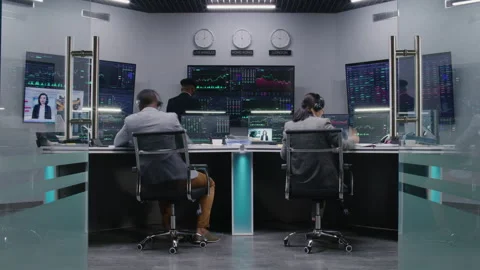 Team of traders work on computers with stocks Stock Footage 242949519