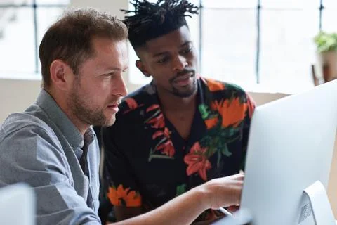 Team, training and men at computer with reading for advice, help or feedback at  Stock Photos