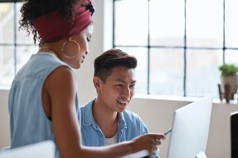 Team, training and people at computer with smile for advice, help or feedback at Stock Photos
