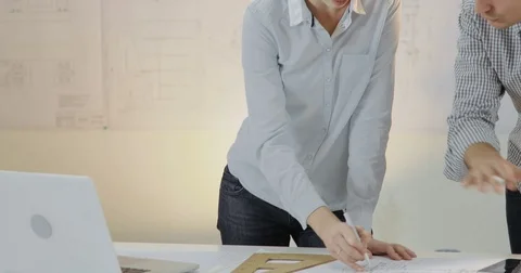 A team of two designers are working the project Stock Footage 81578247