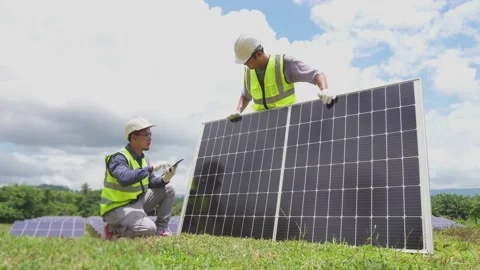 A team of two engineers are working to install solar panels. Stock Footage 210817631