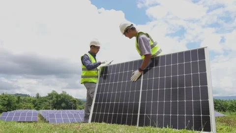 Team of two engineers are working to install solar panels. Stock Footage 210817856