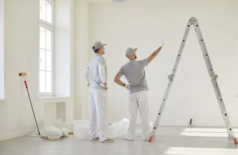 Team of two painters or decorators planning room design ready for house Stock Photos