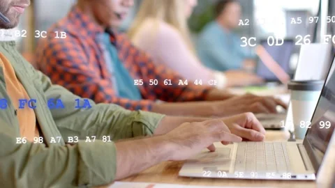 Team typing on laptops at desk, camera shifting ahead while hex data overlay Stock Footage 333595003
