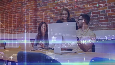 Team typing at table, tech code moving, fourth person leaning in reviewing Stock Footage 333062766