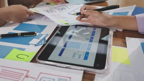 Team of UI UX web designer are working together to develop mobile responsiv.. Stock Footage 310534492
