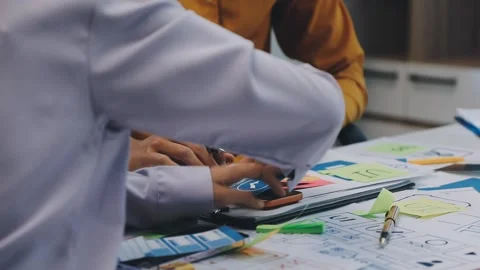 Team of UI UX web designer are working together to develop mobile responsiv.. Stock Footage 330333915