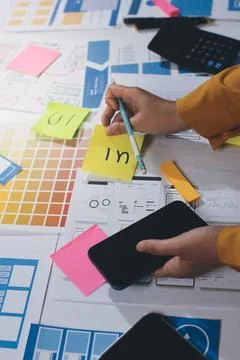 Team of UI UX web designer are working together to develop mobile responsiv.. Stock Photos