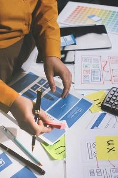 Team of UI UX web designer are working together to develop mobile responsiv.. Stockfoto's
