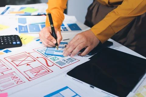 Team of UI UX web designer are working together to develop mobile responsiv.. Stockfoto's