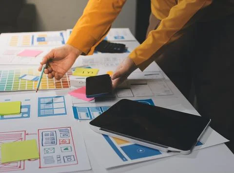 Team of UI UX web designer are working together to develop mobile responsiv.. Stock Photos