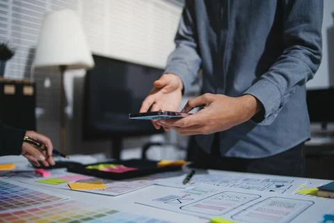 Team of UI UX web designer are working together to develop mobile responsiv.. Stock Photos