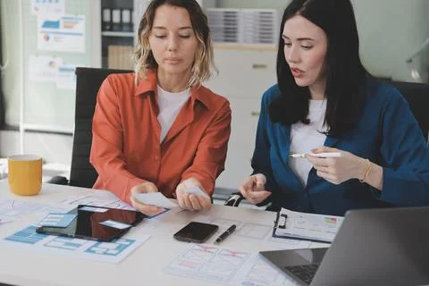 Team of UI UX web designer are working together to develop mobile responsiv.. Stock Photos