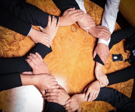 Team Unity, Diverse Hands Joined Together Around Wooden Table in Collaborat.. Stock Photos