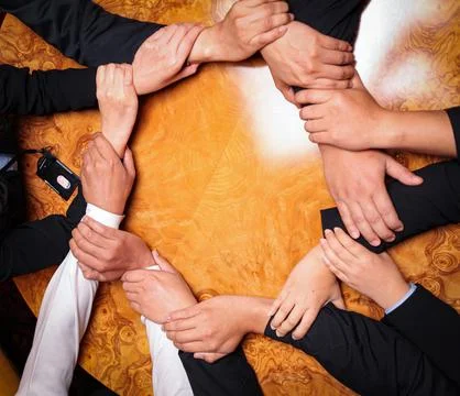 Team Unity, Diverse Hands Joined Together Around Wooden Table in Collaborat.. Stock Photos