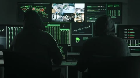 Team of unrecognizable Computer hackers coding and using monitor screens to Stock Footage 228021104