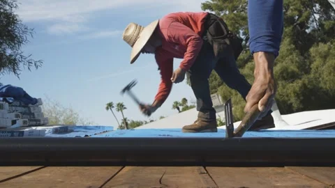 Team Unrolling Plastic Roofing Membrane on House Stock Footage 329402324