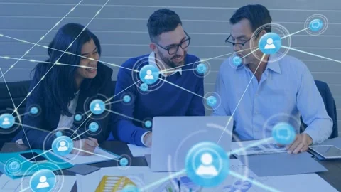 Team using laptop and design mockups, small icon appearing, expanding into Stock Footage 332981754