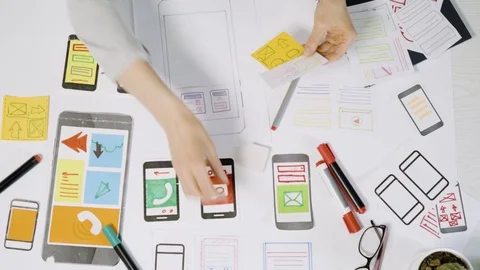 A team of UX creative designers  web application development for mobile phones.  Stock Footage 125403362