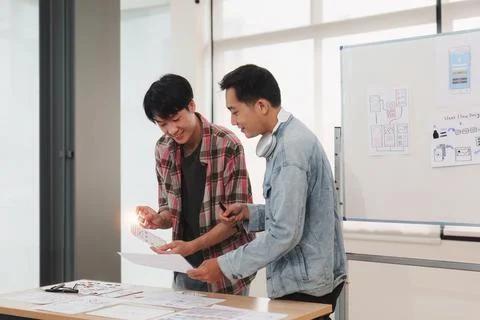 Team of ux developer and ui designer brainstorming interface wireframe design Stock Photos