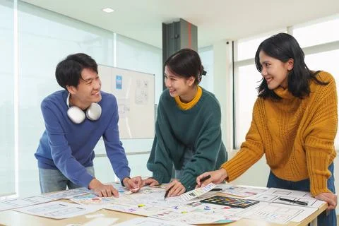 Team of ux developer and ui designer brainstorming interface wireframe design Stock Photos