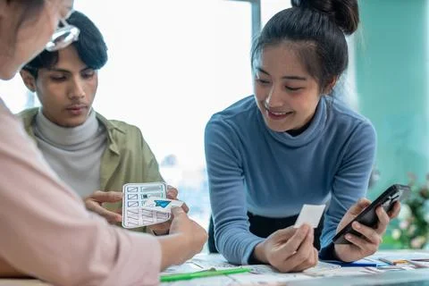 Team of ux developer and ui designer brainstorming interface wireframe design Stock Photos