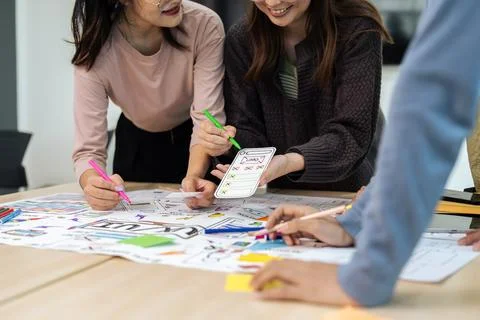 Team of ux developer and ui designer brainstorming interface wireframe design Stock Photos