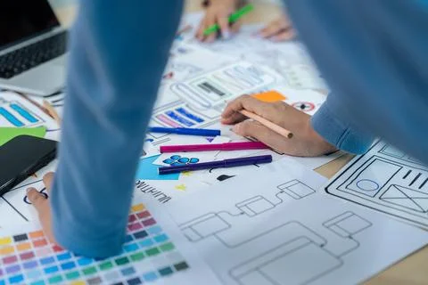 Team of ux developer and ui designer brainstorming interface wireframe design Stock Photos