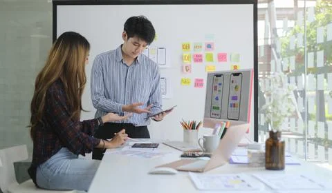 Team of ux developer brainstorming and discussing about mobile app wireframe  Stock Photos
