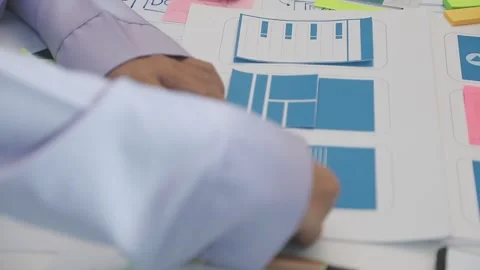 Team of uxui designers pointing at computer screen, discussing new mobile a.. Stock Footage 329540571