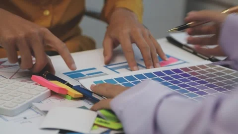 Team of uxui designers pointing at computer screen, discussing new mobile a.. Stock Footage 329540578