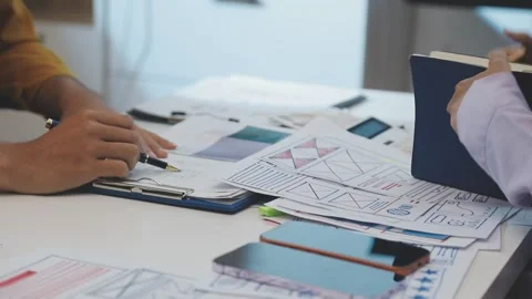 Team of uxui designers pointing at computer screen, discussing new mobile a.. Stock Footage 329540681