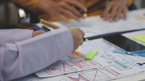 Team of uxui designers pointing at computer screen, discussing new mobile a.. Stock Footage 329540694