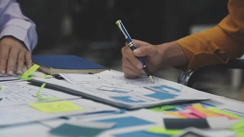 Team of uxui designers pointing at computer screen, discussing new mobile a.. Stock Footage 329540722