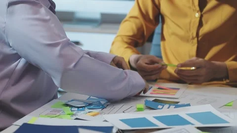Team of uxui designers pointing at computer screen, discussing new mobile a.. Stock Footage 329540896
