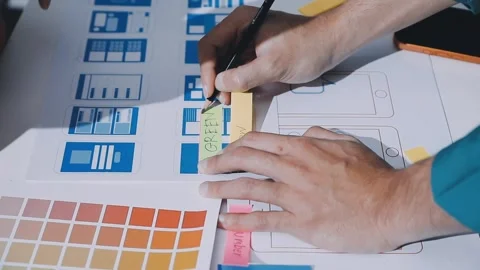 Team of uxui designers pointing at computer screen, discussing new mobile a.. Stock Footage 330325622