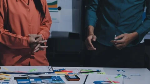 Team of uxui designers pointing at computer screen, discussing new mobile a.. Stock Footage 330325816